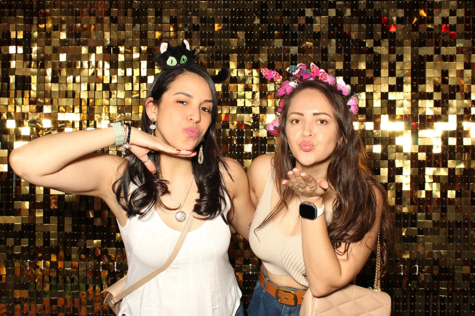 Friends posing on a gold sequin wall at a girls' night